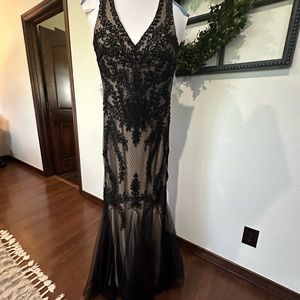 Worn once, purchased at Dillards.  Has been cleaned and is bagged.